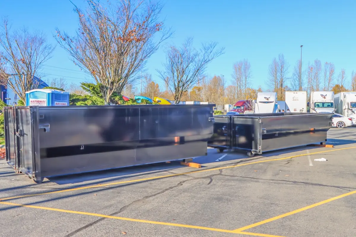 Professional dumpster rental service with roll-off container on residential driveway in North Branch
